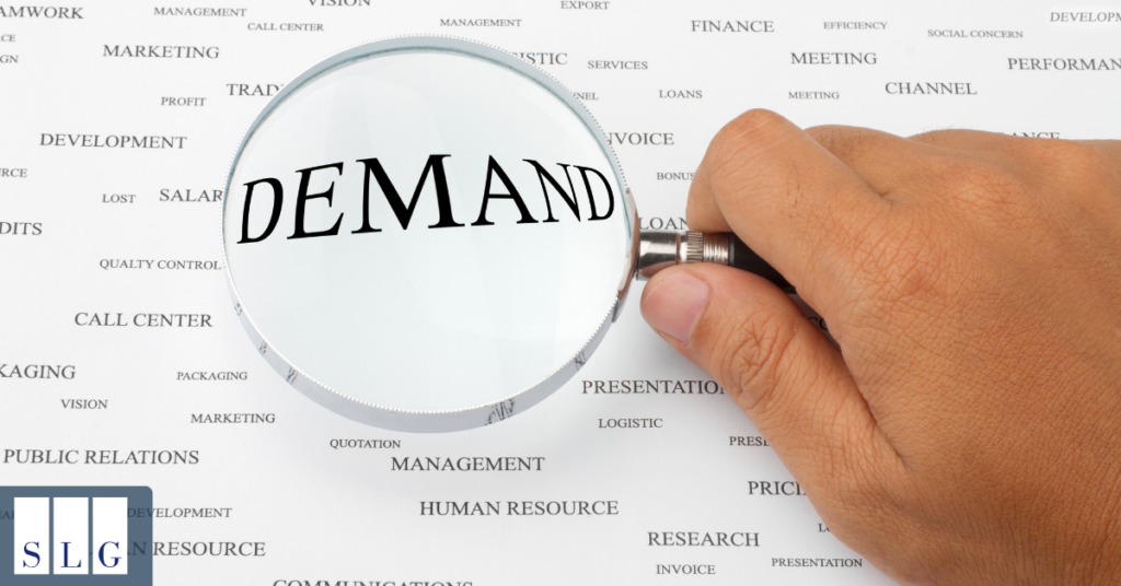 Magnifying glass highlighting the word “Demand” to illustrate a legal demand letter.