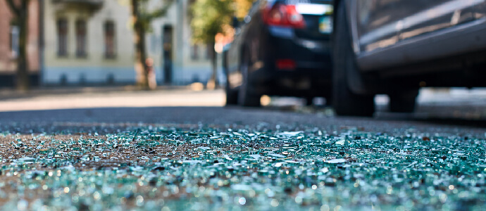 street view of windshield glass on ground, car accident