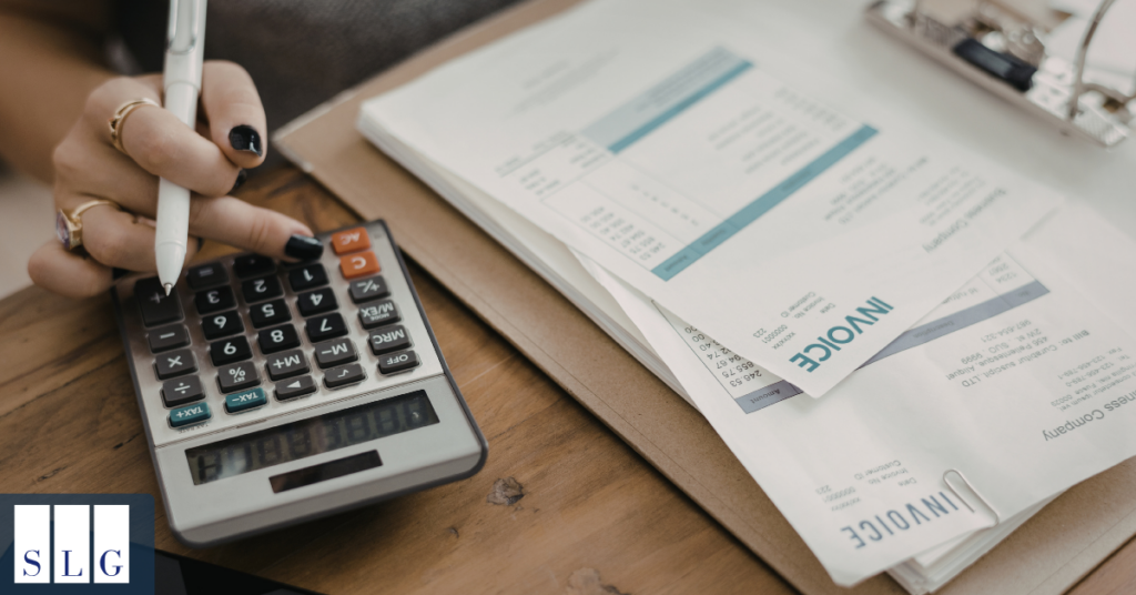 Calculator and documents showing medical bills and expenses