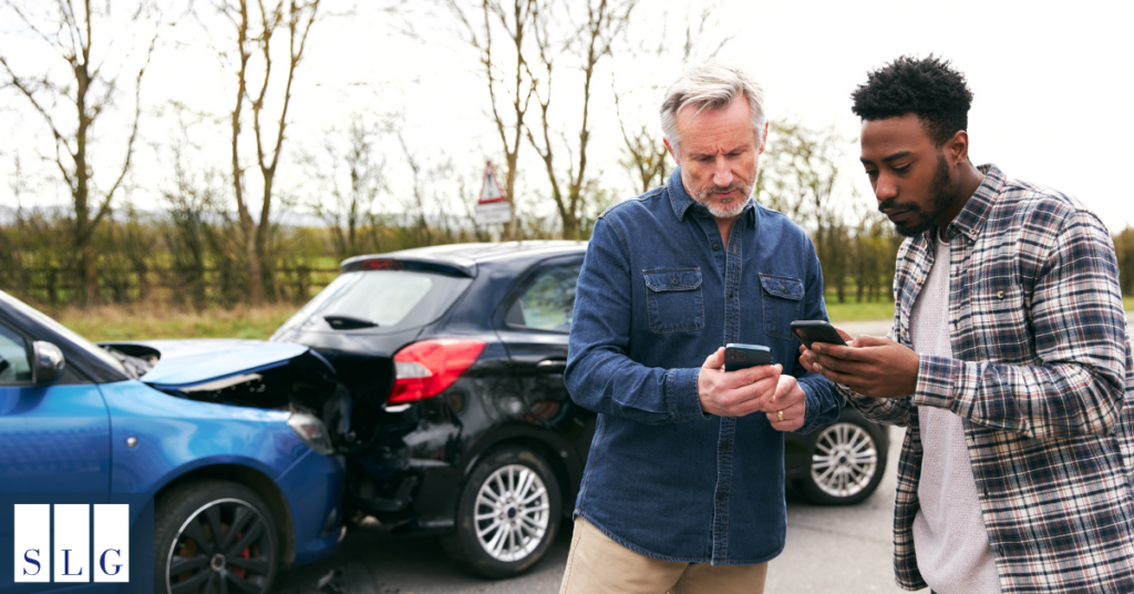 Drivers exchanging insurance and contact information after accident
