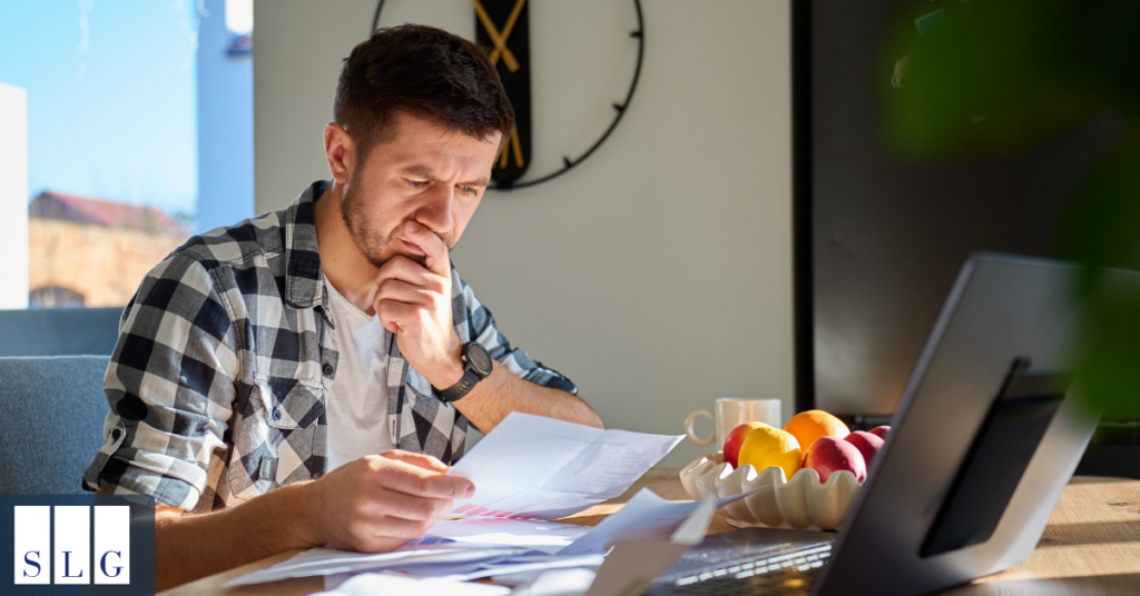 Person organizing medical bills and treatment records after car accident