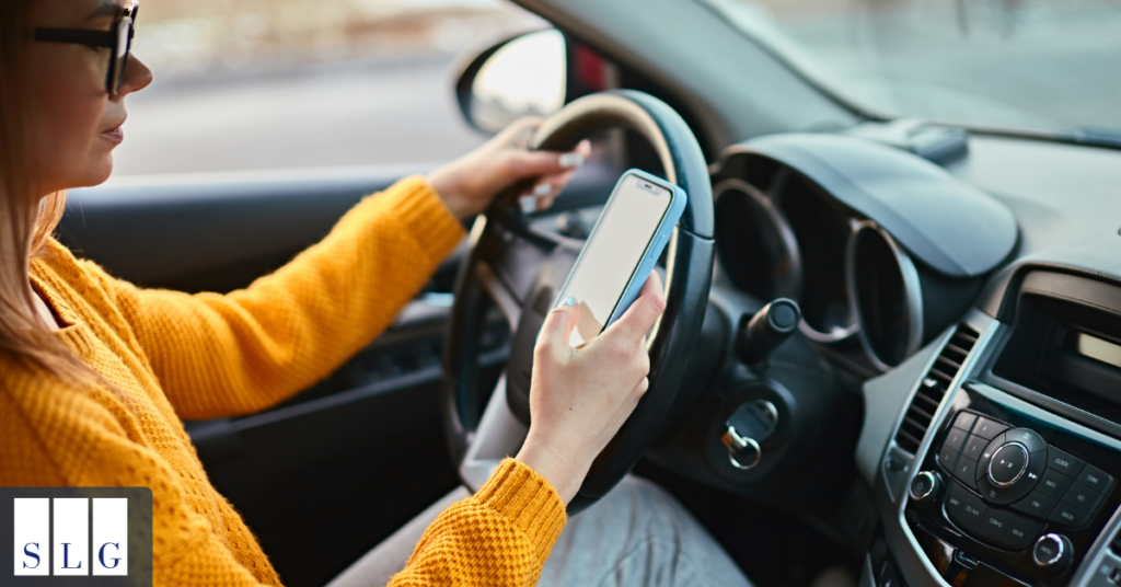 Driver using a mobile phone while driving in traffic