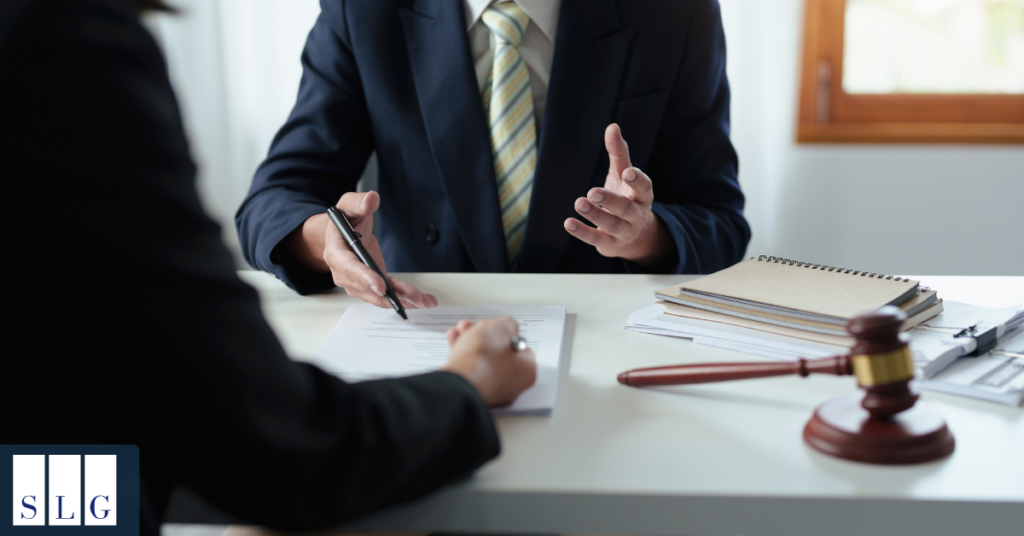 Personal injury attorney reviewing cervical spine injury settlement documents