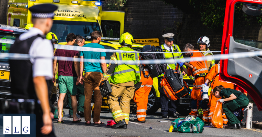 Emergency responders, firefighters, police officers, and paramedics attending a serious traffic accident scene.