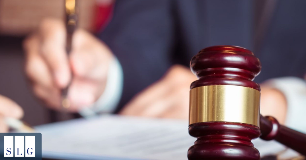 Judge’s gavel with an attorney reviewing documents for a personal injury claim.