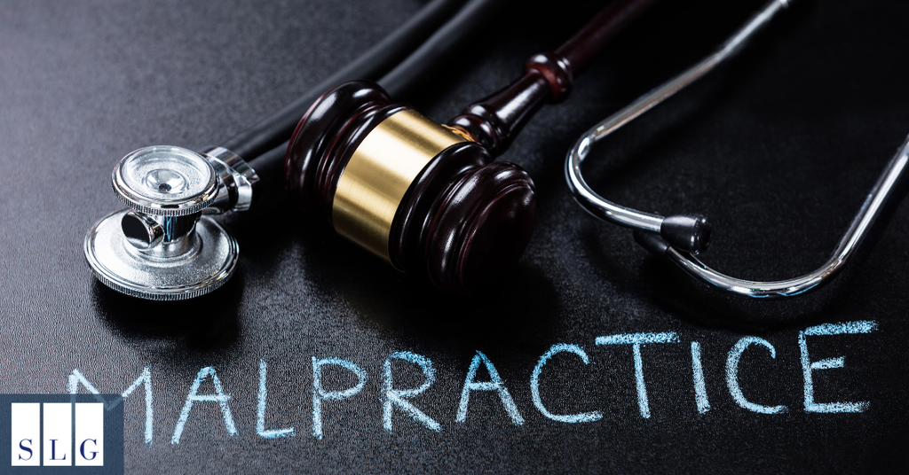 Wooden judge's gavel and medical stethoscope on a black surface with the word malpractice, representing medical negligence lawsuits in California.